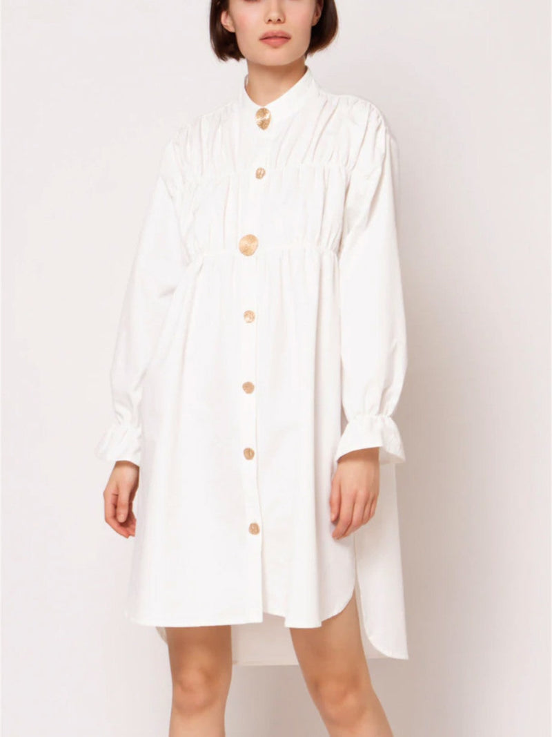 Front view of loose white top with  golden buttons, long sleeves, Semi-Stretch Fabric, 100% Polyester